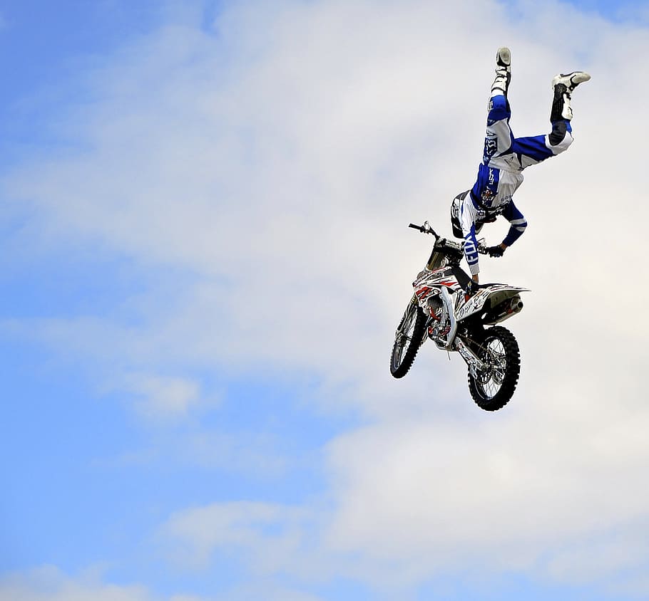 soaring motocross daredevil, motorcycle, stunt, dirt bike, motorbike, sky, mid-air, extreme sports, transportation, helmet