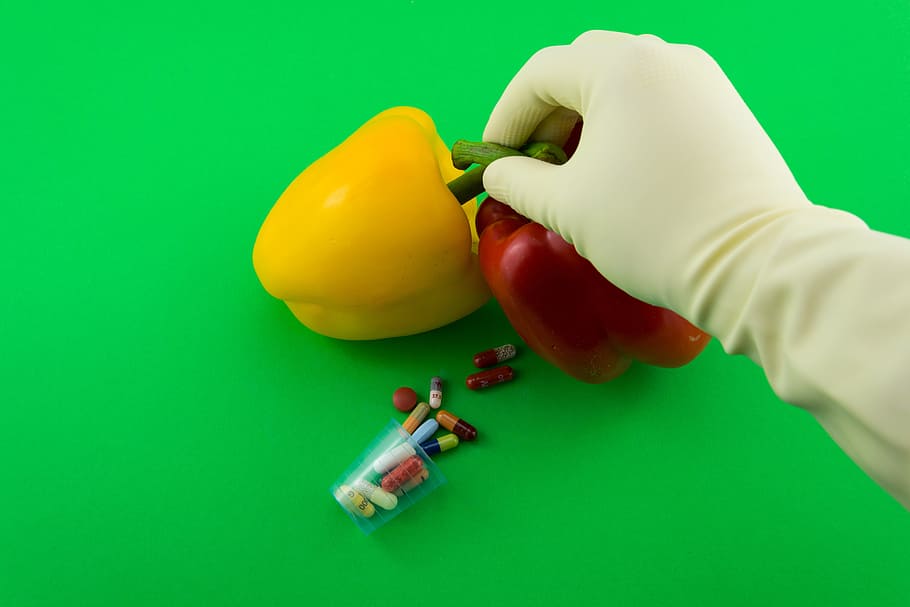 right person, hand, holding, two, red, yellow, bell peppers, Paprika, Science, Drug