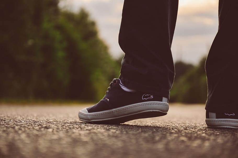 selective, focus photography, person, showing, pair, black, lacoste low-top sneakers, wearing, pants, lacoste
