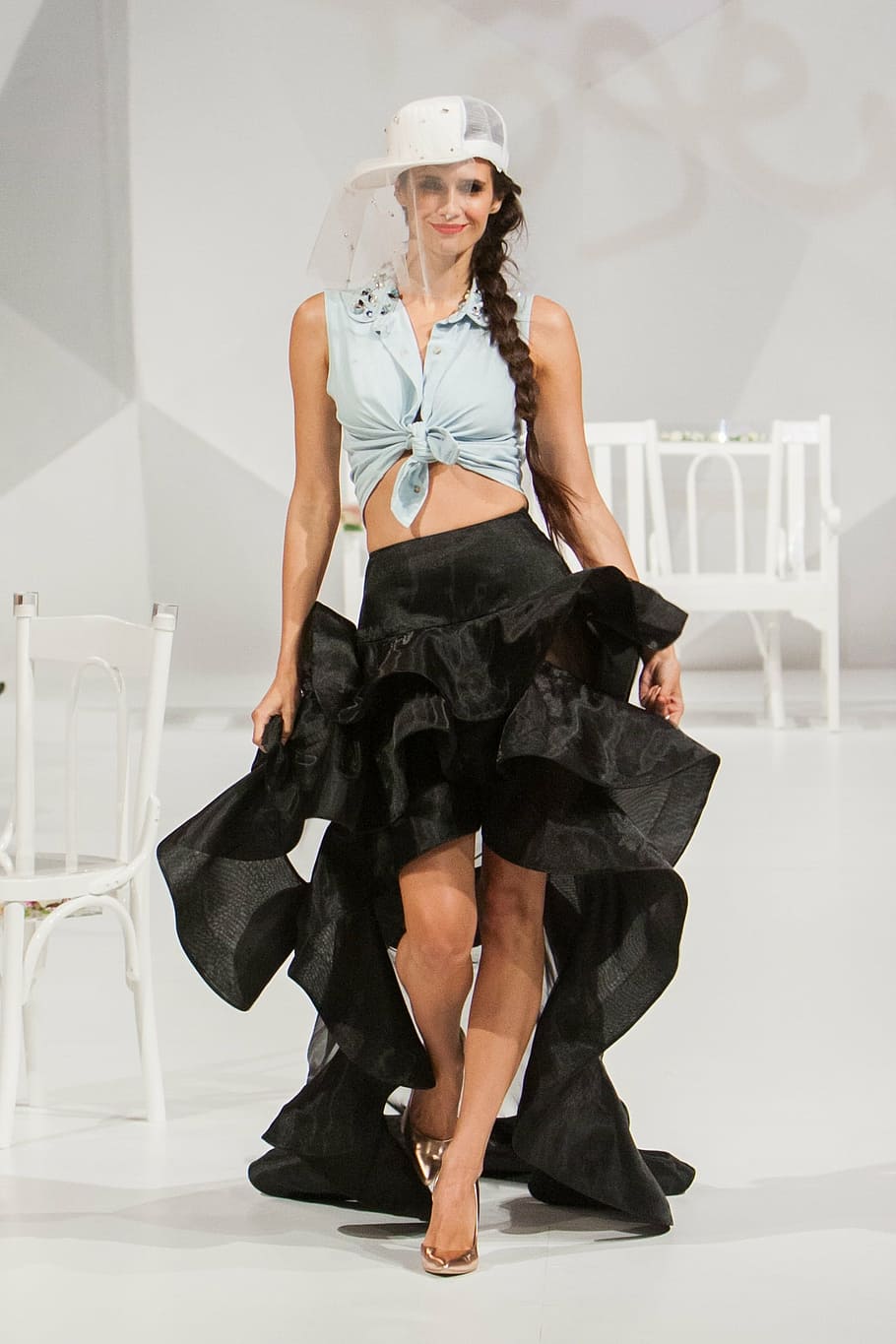 woman, wearing, white, crop, top, black, ruffled, high-low skirt, walking, floor stage
