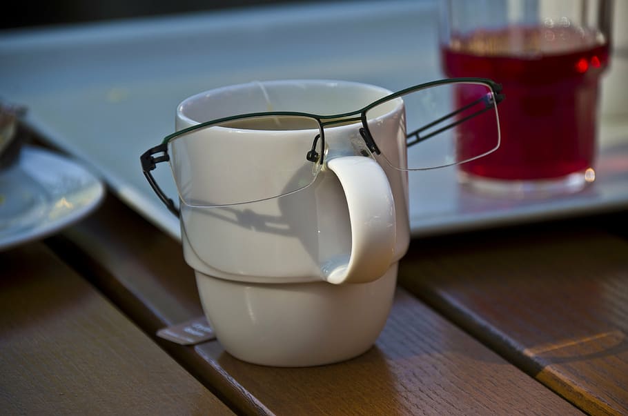 glasses, cup, face, refreshment, drink, food and drink, household equipment, drinking glass, table, indoors