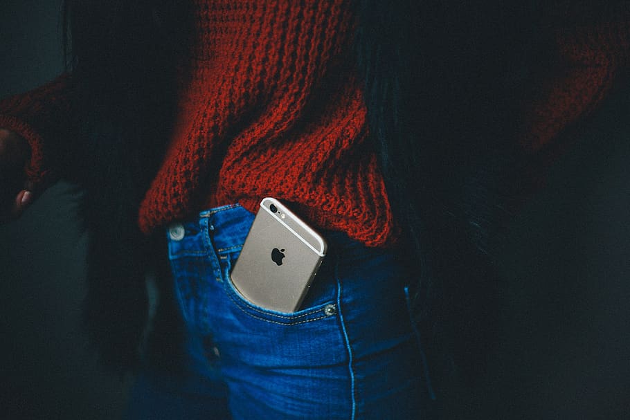 phone, cellphone, apple, iphone, pocket, one person, jeans, casual clothing, clothing, indoors
