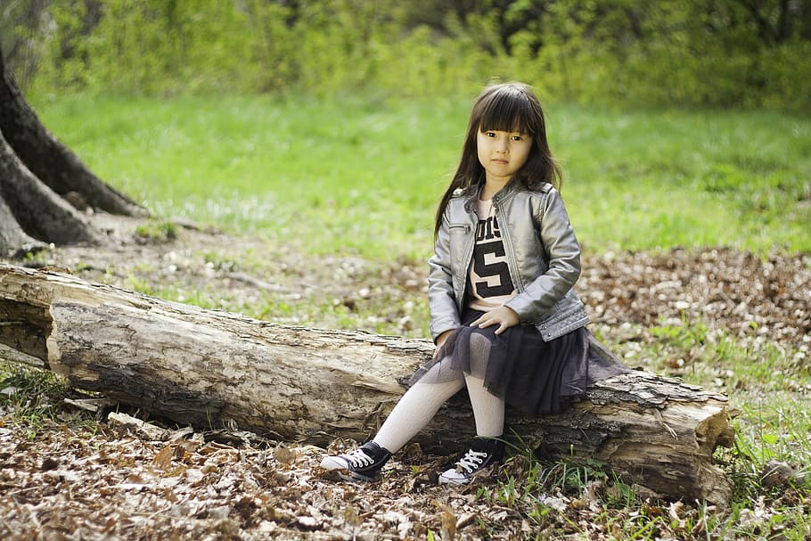 girl, sitting, tree, tuck, grass field, portrait, child, smile, joy, shy