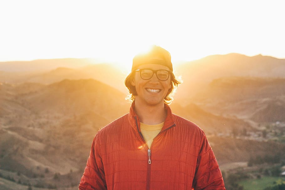 glasses, with smile standing, sunlit mountains, Man, smile, standing, sunlit, mountains, people, light