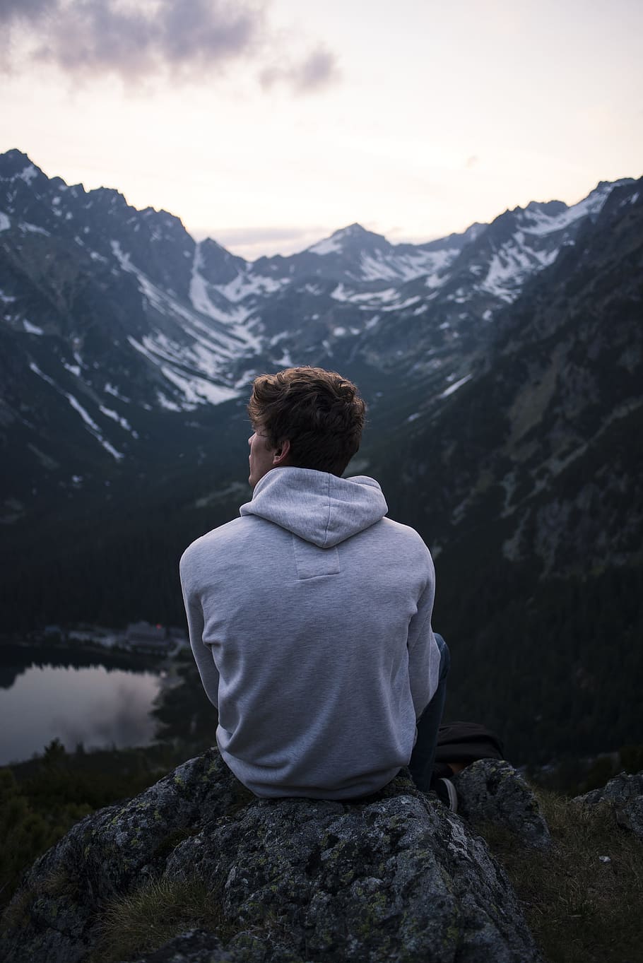 man, sitting, rock, facing, mountain, alone, lake, nature, person, solo