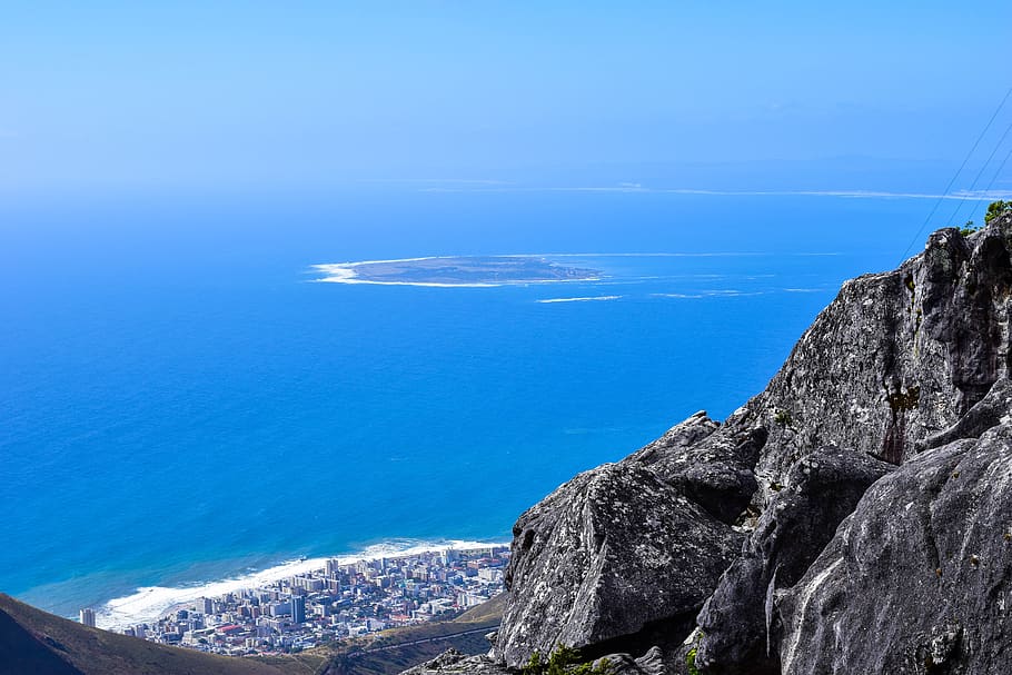 aerial from table mountain, south africa, cape town, mountain, rock, city, robben island, ocean, rocks, mandela