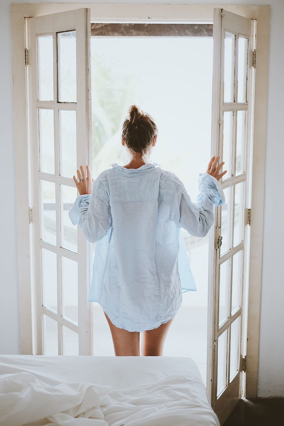 woman, standing, door, holding, open, wearing, white, dress shirt, bed, bedroom