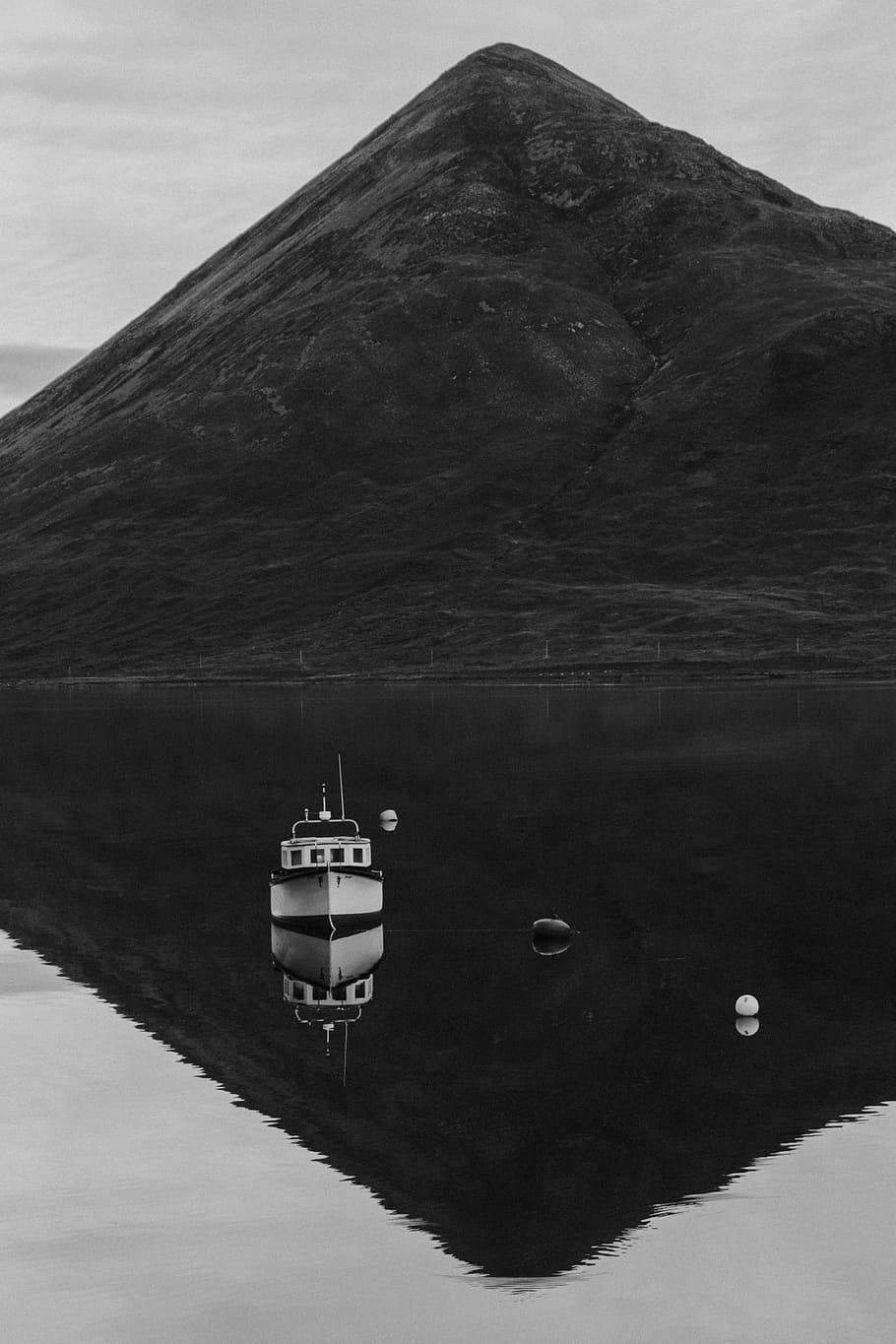 grayscale photography, ship, body, water, mountain, highland, sky, lake, reflection, boat