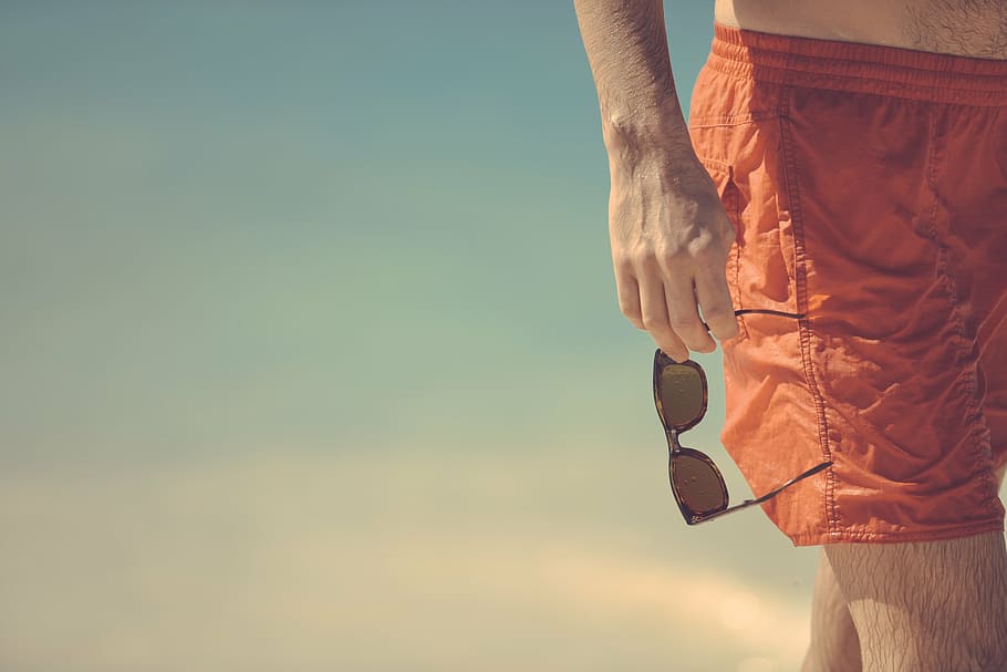 man, holding, sunglasses, seashore, beach, red, shorts, bermudas, hand, summer