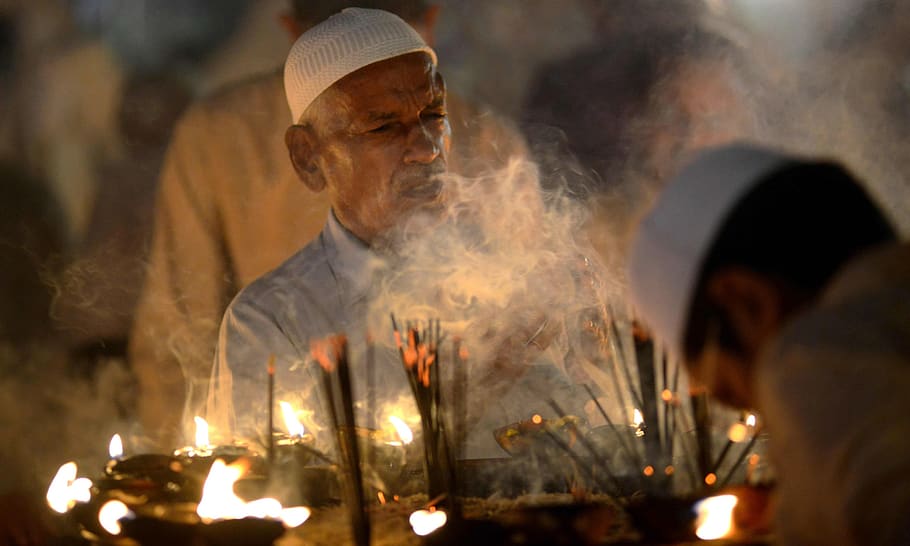 lahore, data shrine, pakistan, smoke - physical structure, burning, fire, fire - natural phenomenon, adult, flame, heat - temperature