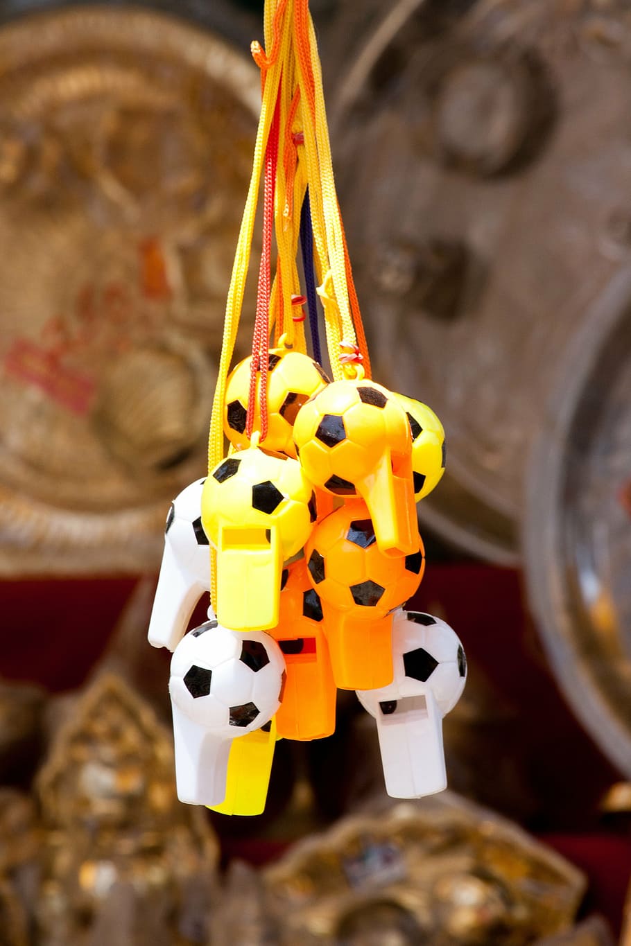 whistles, hanging, sound, yellow, toy, shop, focus on foreground, close-up, indoors, animal