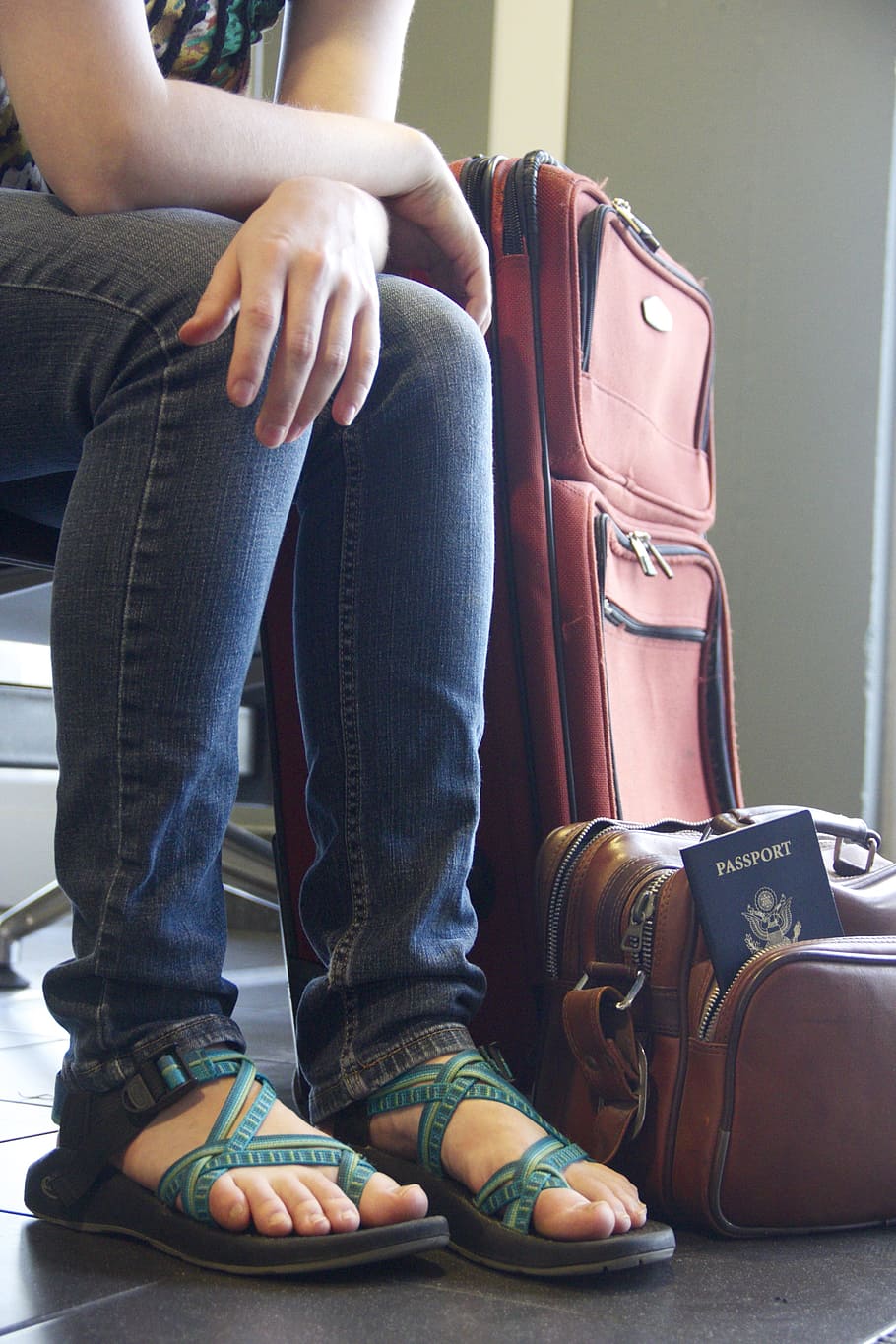 person, sitting, chair, travel luggage, travel, luggage, airport, waiting, passport, traveler