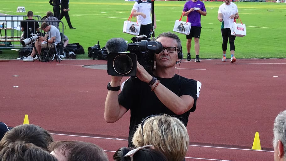 man holding camcorder, cinematographer, photographer, film, video, camera, group of people, real people, people, sport