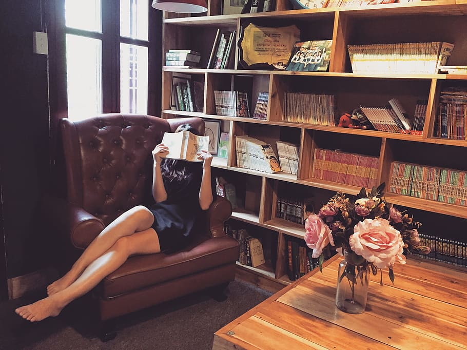 woman, wearing, black, mini dress reading, book, library, asian, books, couch, flower vase