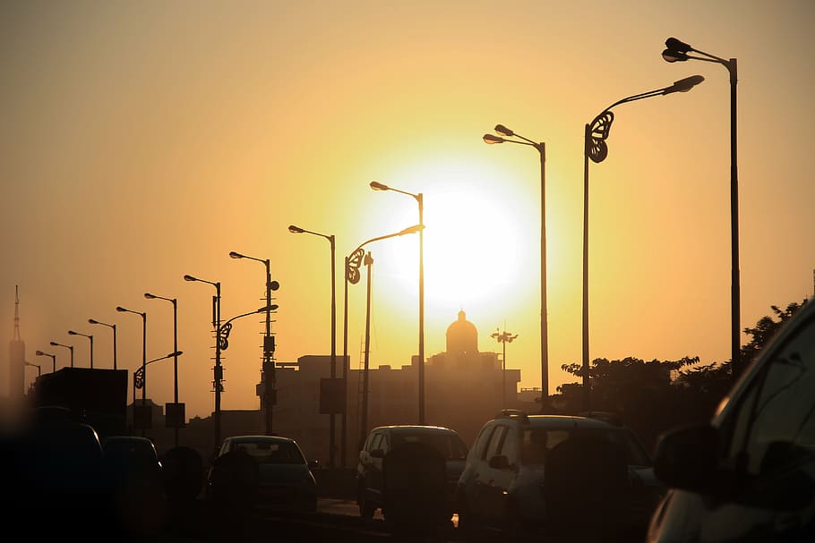 silhouette, parking post lamps, sunset, horizon, orange, sky, moon, light, car, vehicle