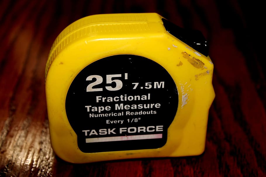 measuring tape, task force, carpentery, yellow, text, communication, close-up, western script, indoors, focus on foreground