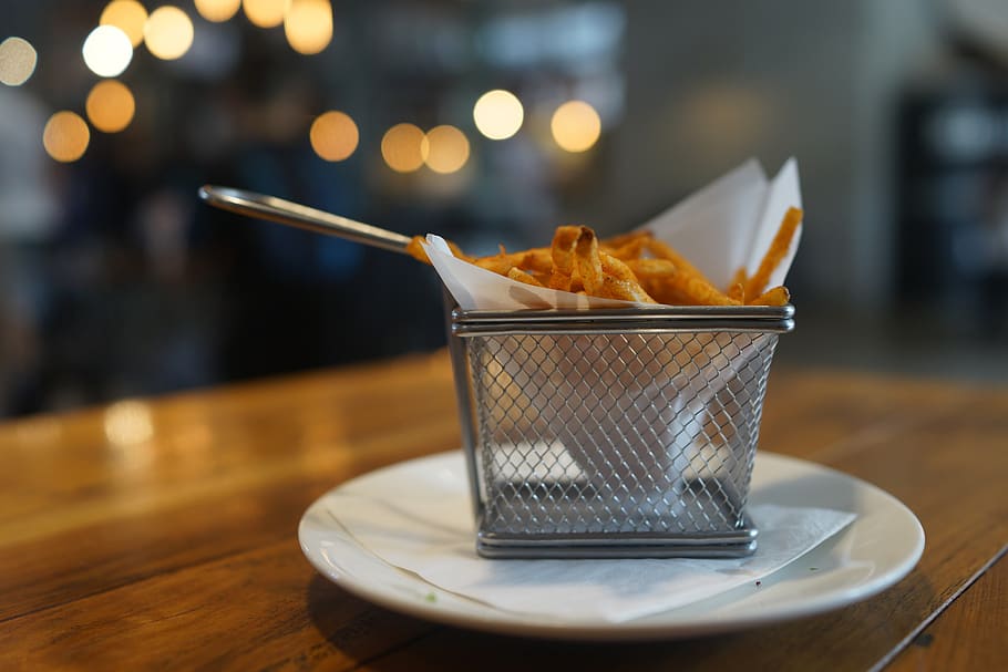 french fries, basket, ambient lights, table, food and drink, food, unhealthy eating, ready-to-eat, focus on foreground, close-up