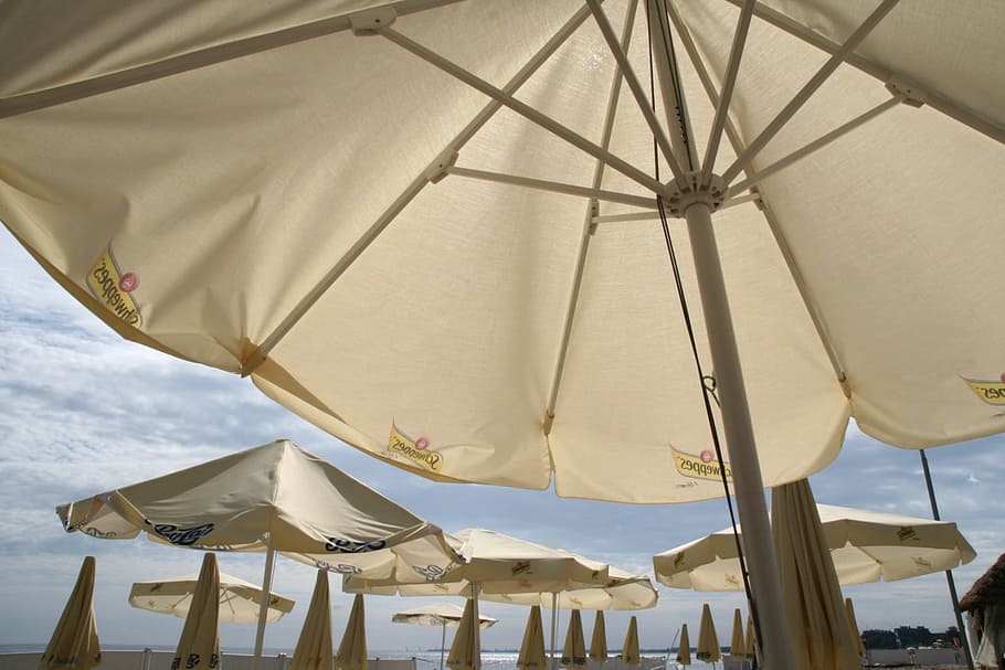 parasols, beach, baltic sea, sea, umbrella, sky, textile, parasol, cloud - sky, low angle view