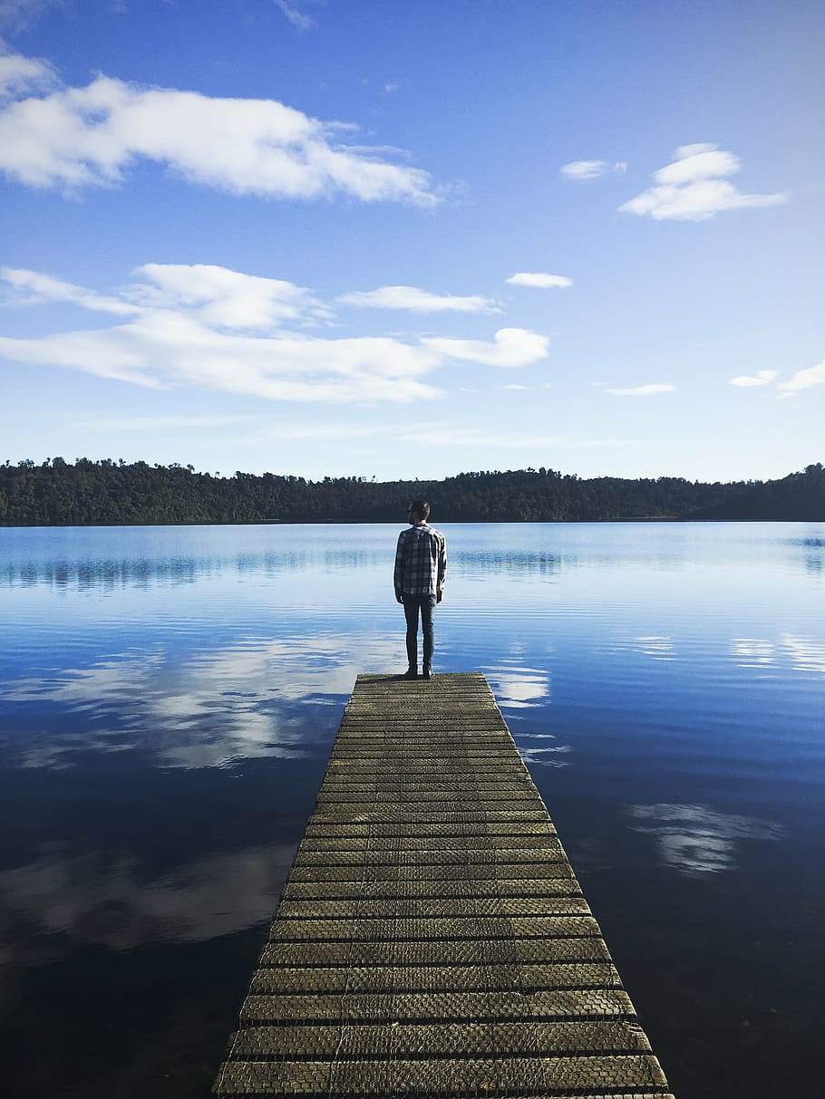 man, standing, wooden, dock, facing, lake, daytime, white, shirt, pathway