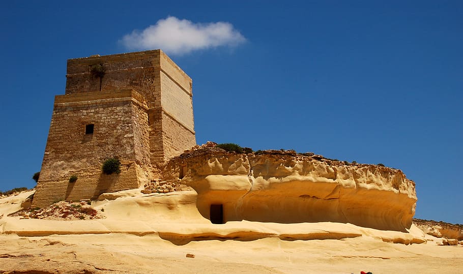 brown concrete buidlign, gozo, malta, castle, fortress, tower, yellow, sky, blue, architecture