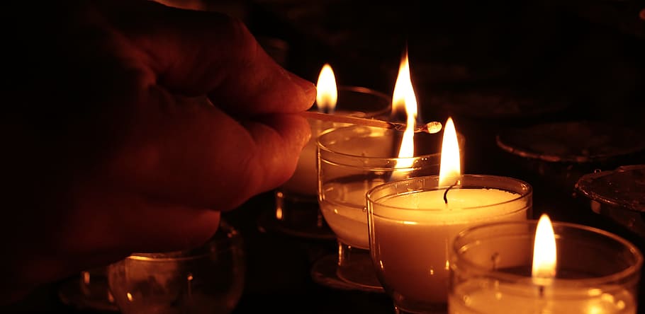 person lighting, votive, candles, tea lights, hand, church, light, prayer, candlelight, faith
