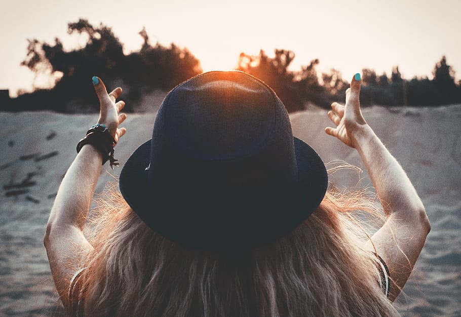 woman, wearing, hat, sitting, sand, dusk, sun, red sun, sunset, dawn