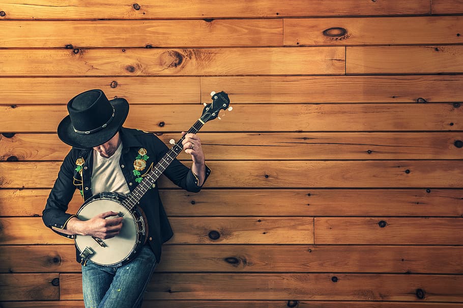 banjo, music, instrument, jeans, hat, wood, paneling, clothing, one person, real people