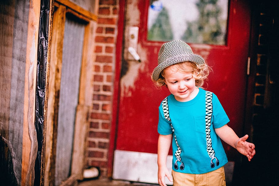 toddler, wearing, blue, crew-neck t-shirt, brown, bottoms, gray, black, fedora hat, red