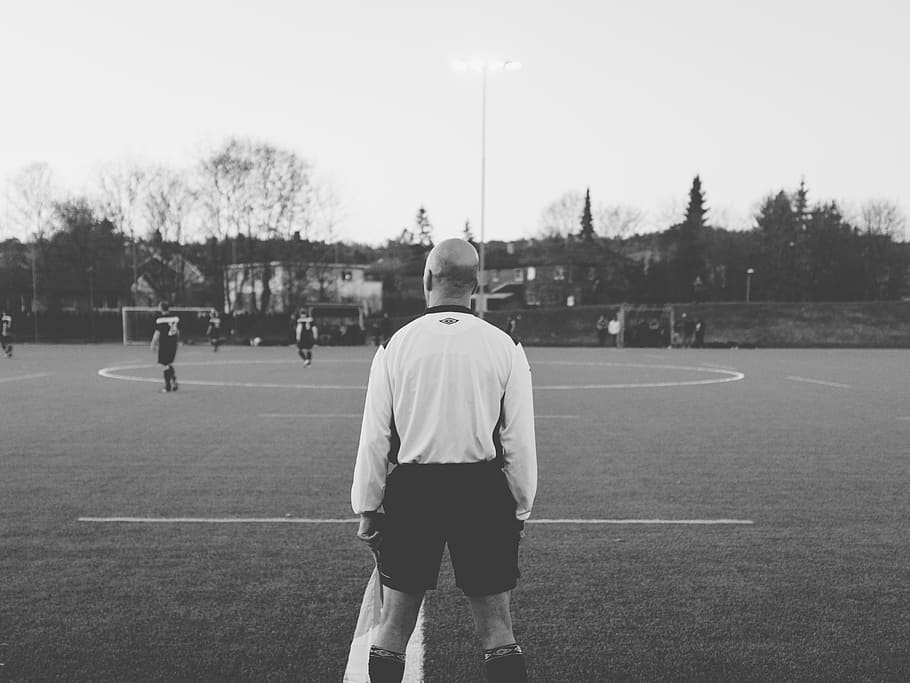 grayscale photography, referee, standing, ballpark, grayscale, photography, soccer, daytime, football, field
