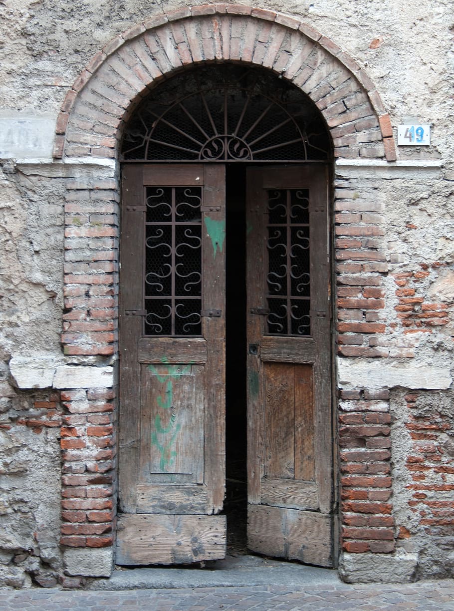 half, opened, brown, wooden, door, old doorway, patched doors, dilapidated, brick arch, lake garda