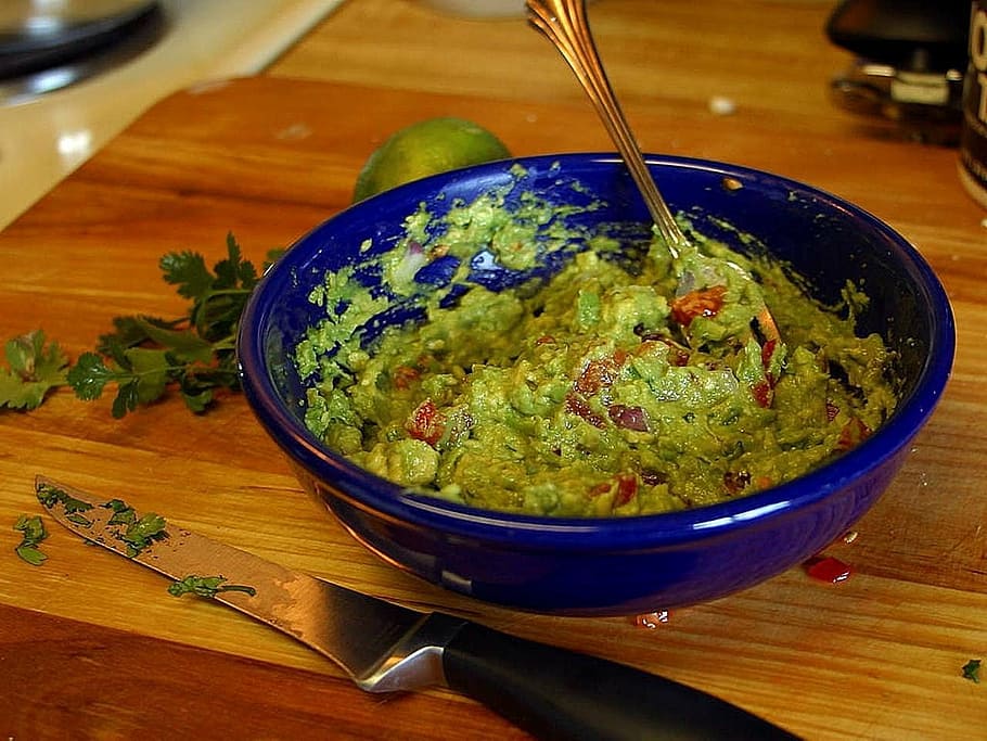 blue ceramic bowl, avocados, guacamole, drink, food, indoors, food and drink, bowl, wood - material, freshness