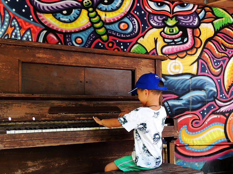 boy using piano, piano, boy, child, playing, happy, sitting, entertainment, colourful, mural