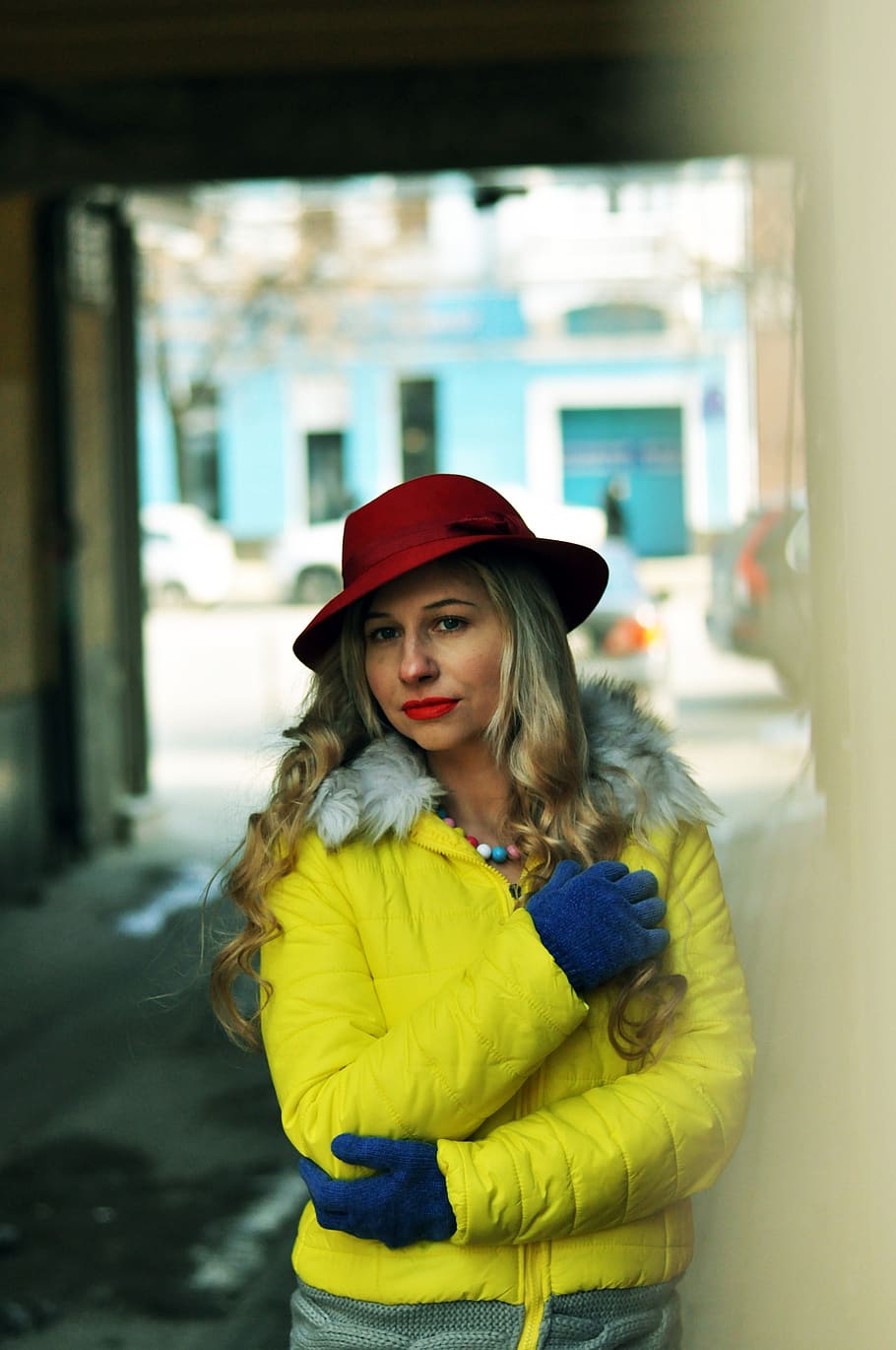 bright jacket, arch house, city, winter, coldly, cap, people, woman, outdoors, portrait