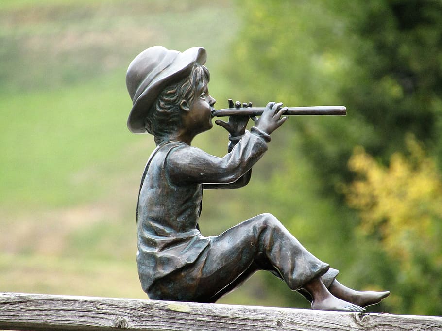 Statuette, Flutist, a cowherd boy, outdoors, focus on foreground, sitting, day, adult, people, art and craft