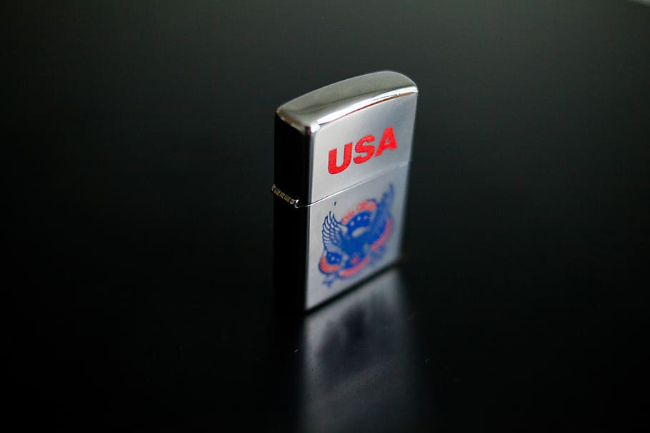 zippo, cigarette lighter, usa, steel, close-up, single object, indoors, communication, safety, text