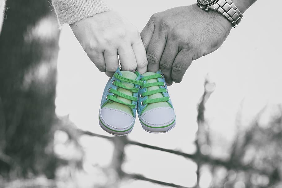 selective, color photo, man, woman, holding, white-and-gray baby shoes, coming soon, newborn, baby, soon