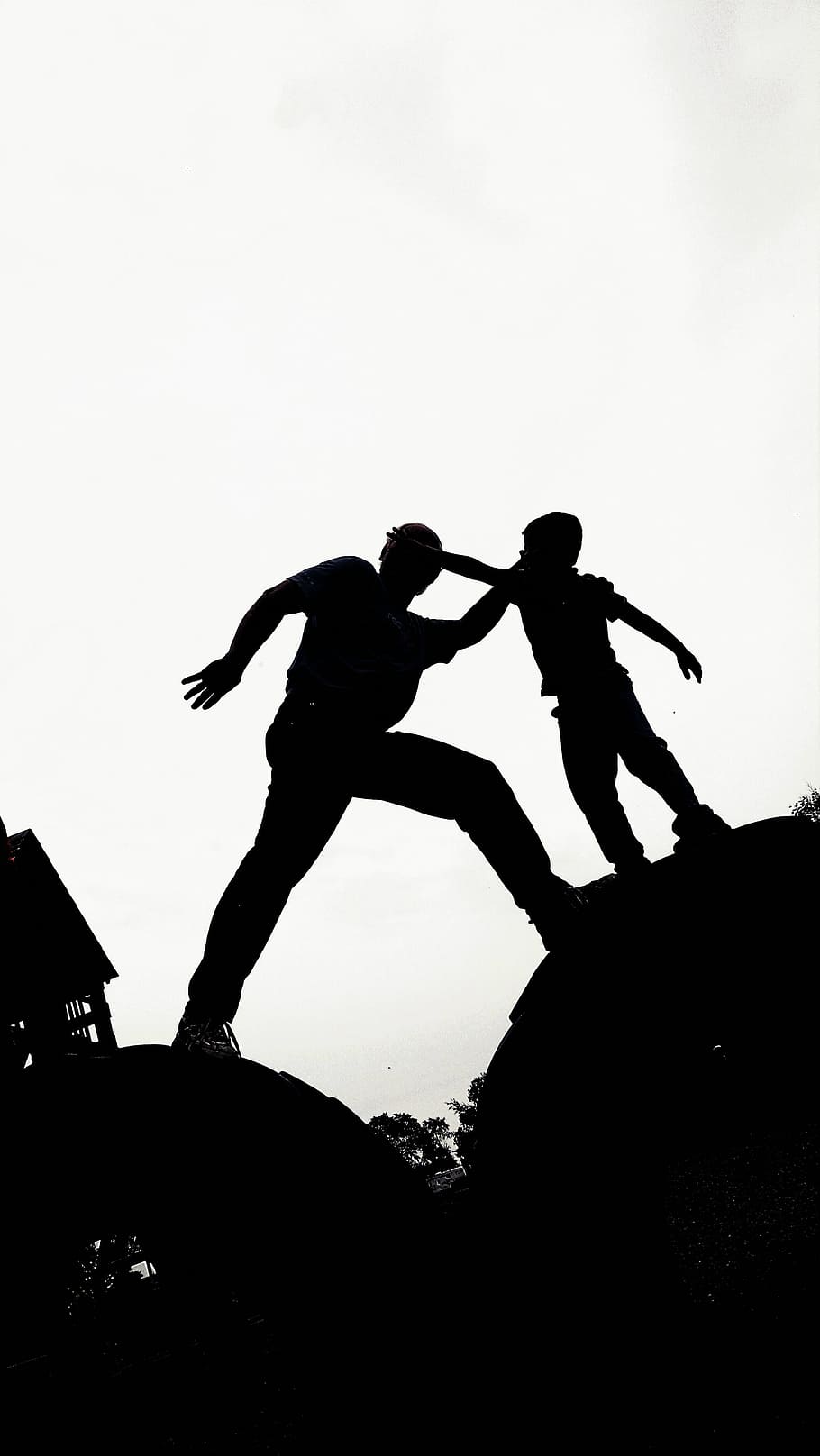 silhouette photo, man, boy, standing, house, daytime, silhouette, father, climbing, son