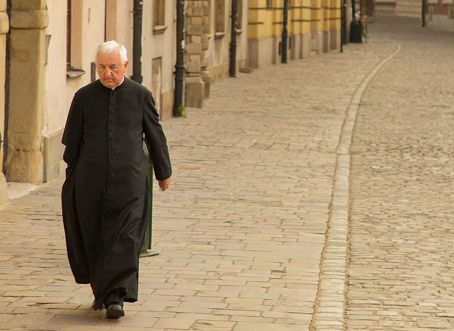 man, wearing, black, cassock, walking, gray, concrete, pavement, daytime, priest
