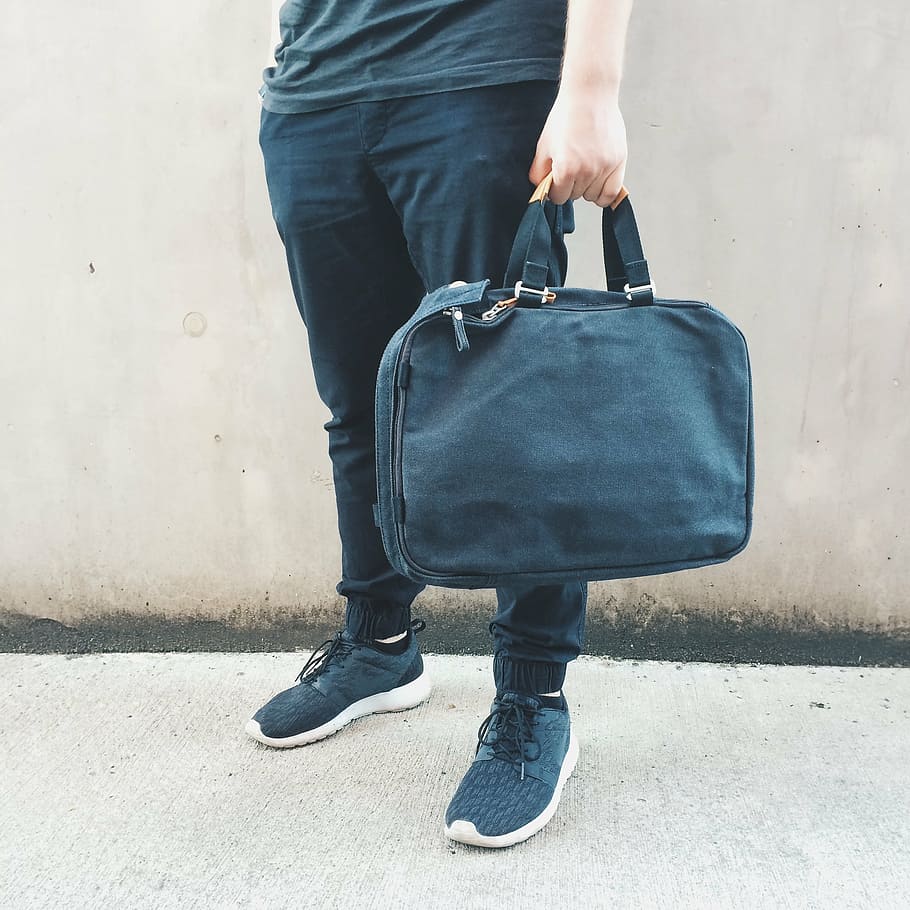 person holding handbag, bag, boy, guy, hipster, luggage, nike, shoes, street, wall