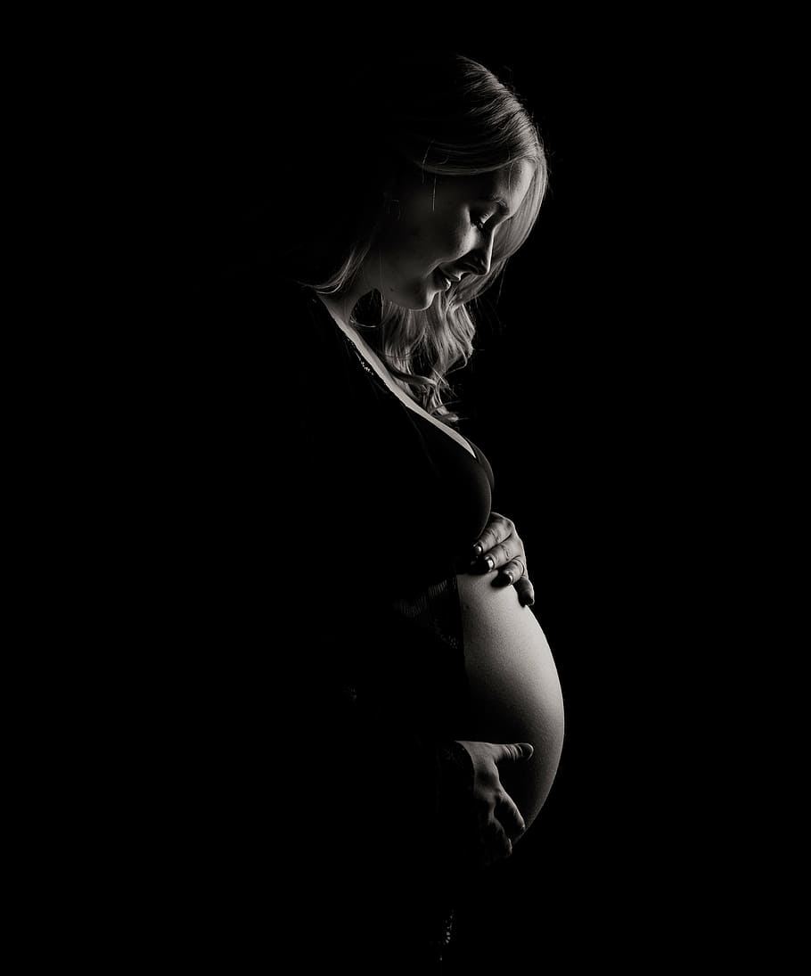 grayscale photo, pregnant, woman, touching, belly, dark, black, white, people, girl