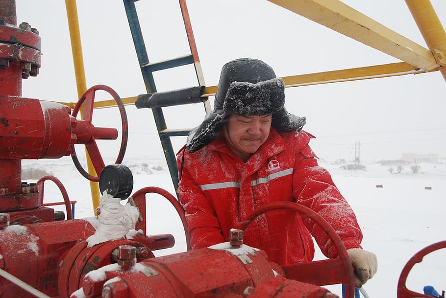 oil workers, in the snow, valve, power, winter, cold temperature, real people, warm clothing, snow, clothing