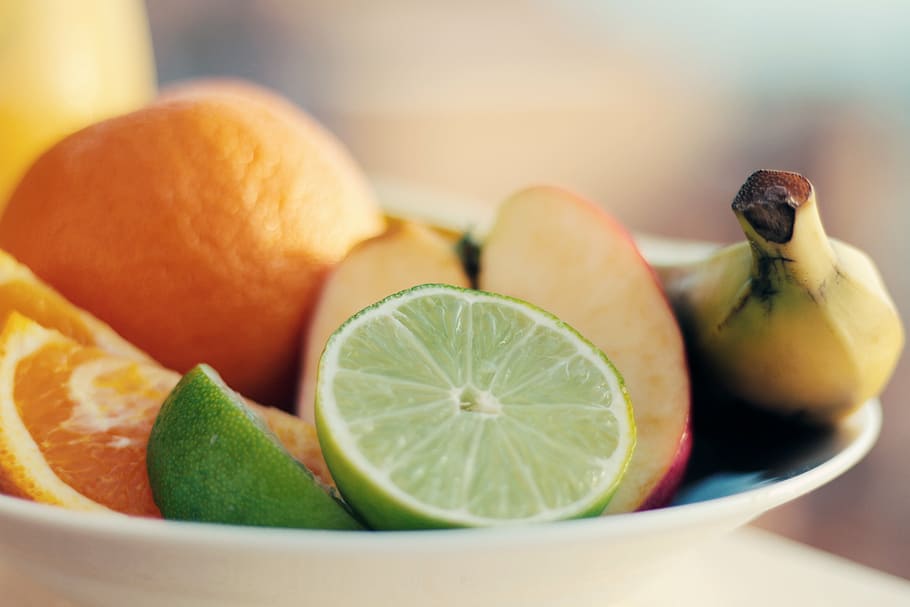selective, focus photography, bowl, fruits, sliced, plated, table, oranges, limes, apples