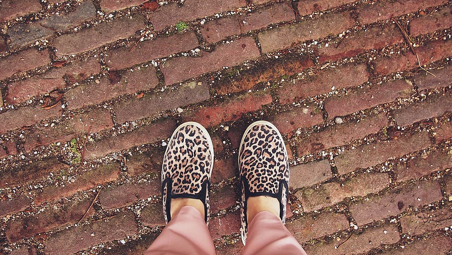 person, wearing, beige-black-and-pink, leopard, print, slip-on, shoes, red, brick, ground