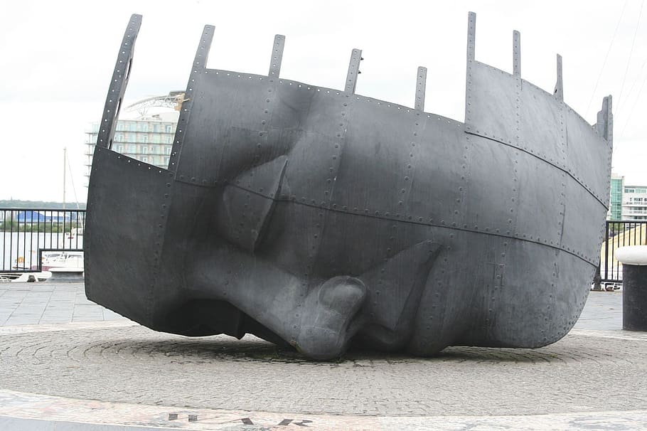 gray, steel face figure, war, memorial, ship, wreck, face, monument, landmark, transportation