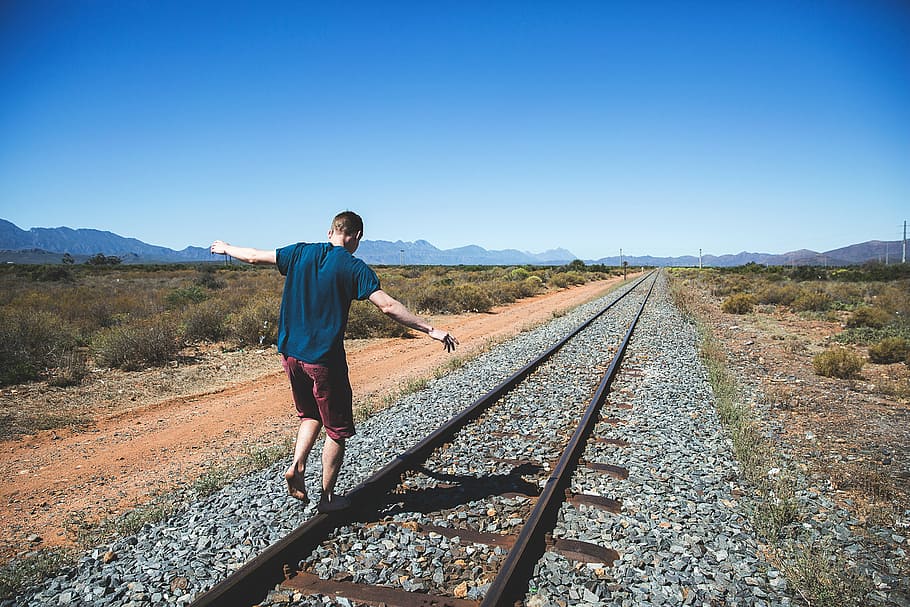 man, standing, train rail, daytime, railway, track, outdoor, mountain, view, sunny