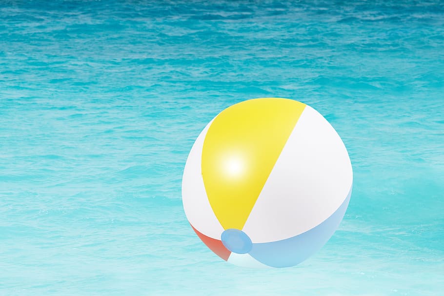 white, multicolored, ball floater, body, water, yellow, blue, and red, red ball, body of water, water polo