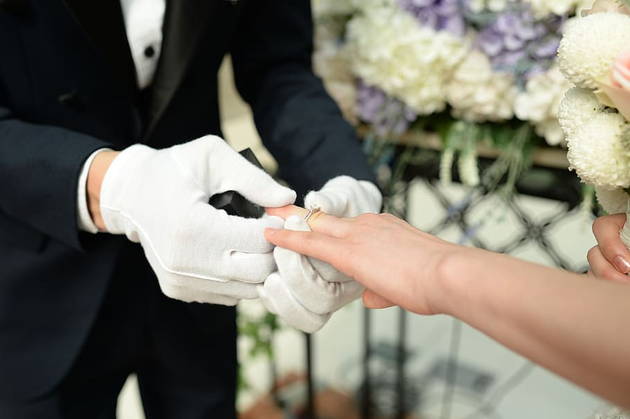 groom, inserting, wedding ring, brides finger, given unprecedented wedding, ring exchange, vows, human hand, hand, two people