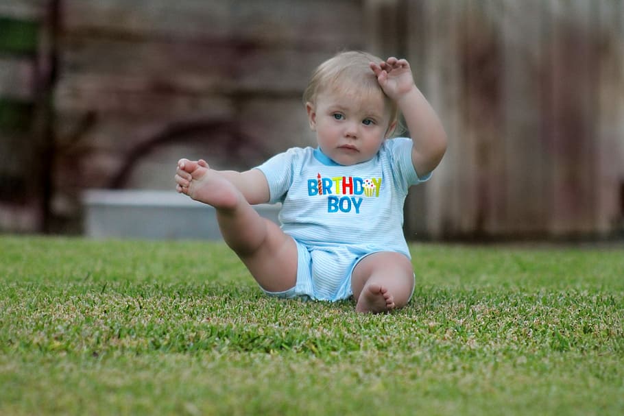 close, photography, boy, sitting, grass field, baby, in blue, onesie, green grass, child