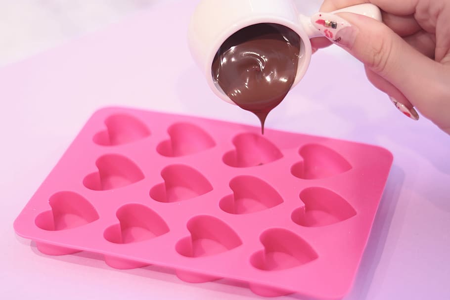 person, pouring, chocolate, pink, heart shape molding tray, heart shape, molding, tray, red, human Hand