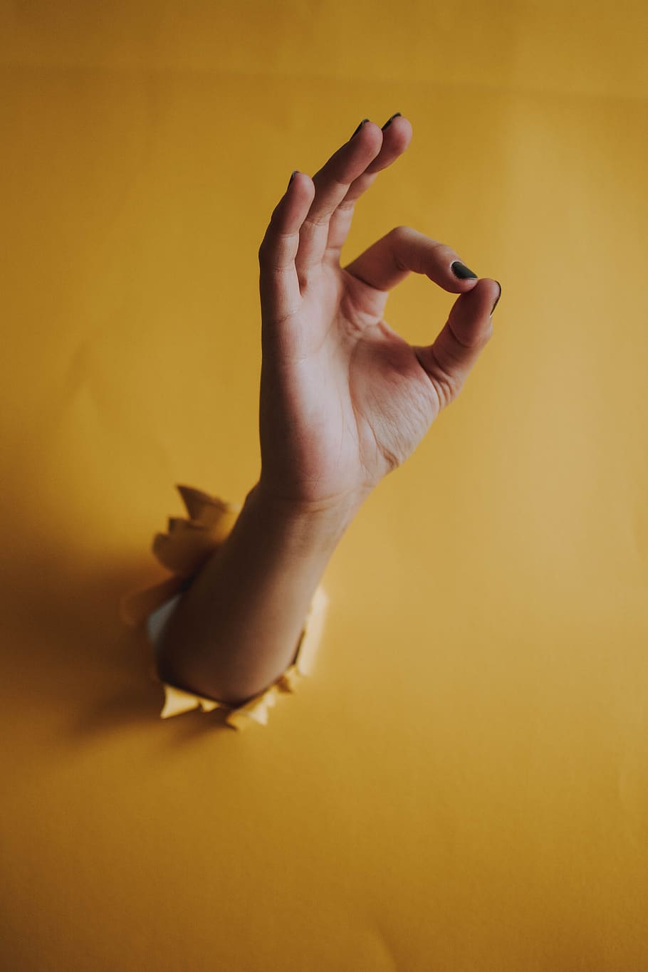 hand, yellow, hole, ok, characters, symbol, human hand, human body part, one person, indoors